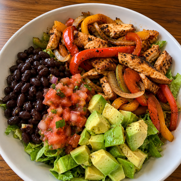 Chicken fajita bowl with peppers onions black beans avocado and salsa
