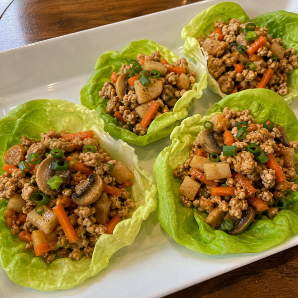 Chicken lettuce wraps with mushrooms carrots and water chestnuts
