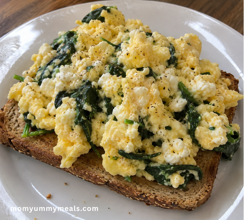 High protein cottage cheese scrambled eggs with spinach on whole grain toast