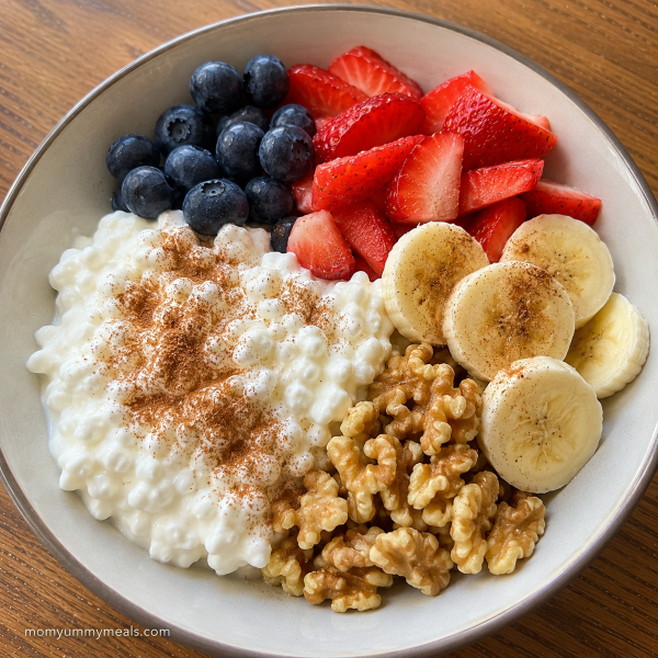 Cottage cheese bowl with fresh fruit walnuts and cinnamon