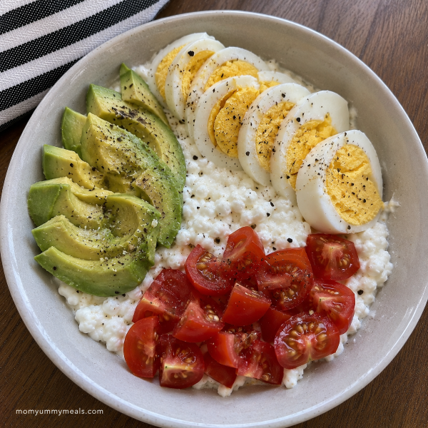 Cottage cheese bowl with hard boiled egg avocado and tomatoes