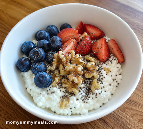 Cottage cheese breakfast bowl topped with berries walnuts and chia seeds