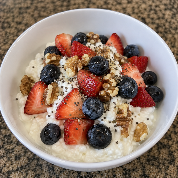 Cottage cheese breakfast bowl with strawberries blueberries walnuts and chia seeds