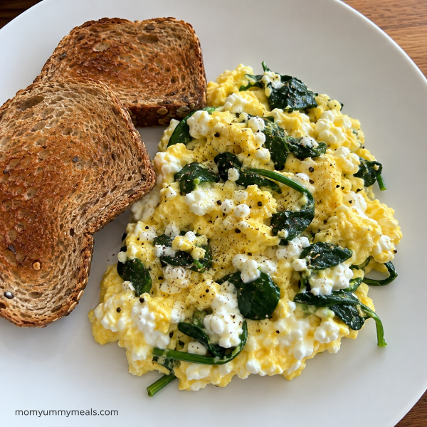 Cottage cheese scrambled eggs with spinach and whole grain toast