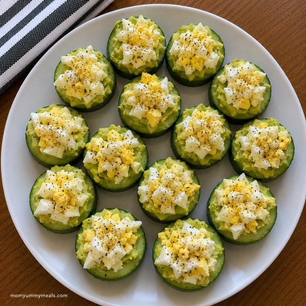 Cucumber bites topped with avocado and chopped hard boiled egg
