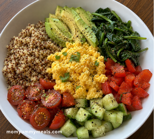 breakfast bowl with eggs quinoa avocado and vegetables