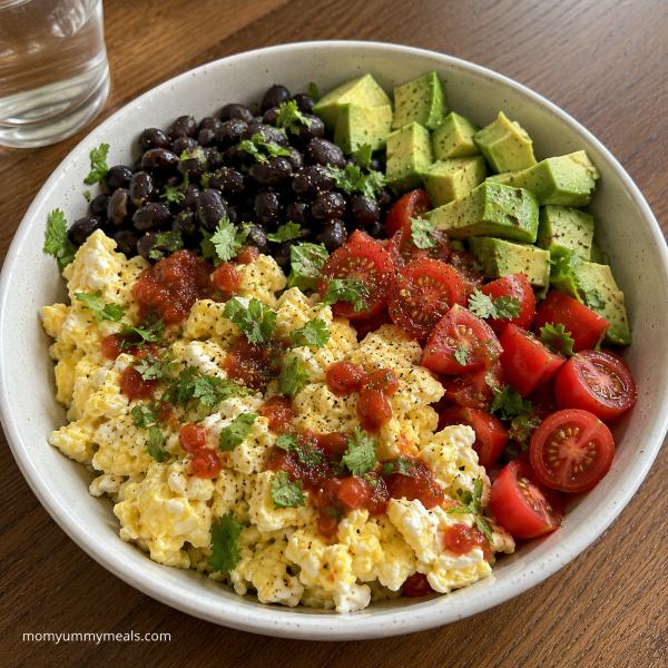 Egg and black bean breakfast bowl with avocado tomatoes and salsa