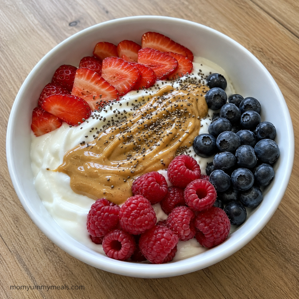 Greek yogurt breakfast bowl with fresh berries chia seeds and peanut butter