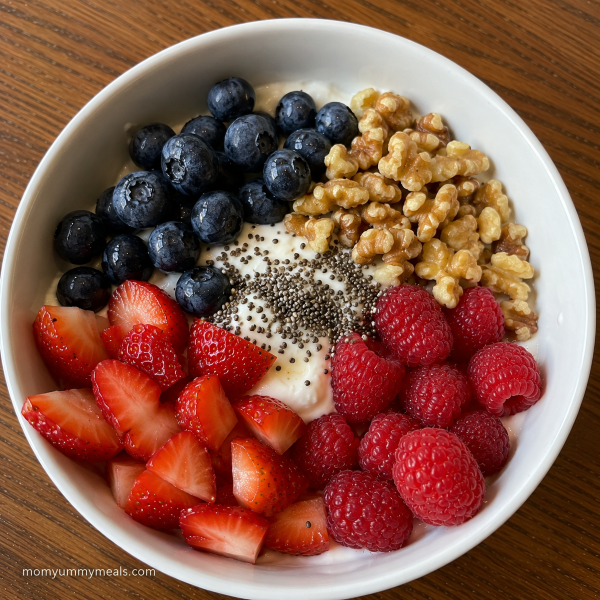 Greek yogurt snack bowl with berries walnuts and chia seeds