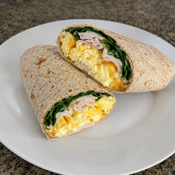 High protein breakfast wrap with scrambled eggs turkey spinach and cheese