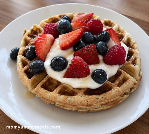 High protein waffles topped with Greek yogurt and fresh berries