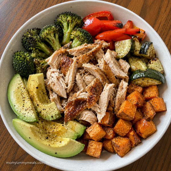 Rotisserie chicken dinner bowl with roasted vegetables avocado and sweet potato
