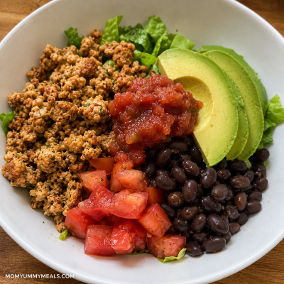 Small turkey taco bowl with black beans avocado tomatoes and salsa