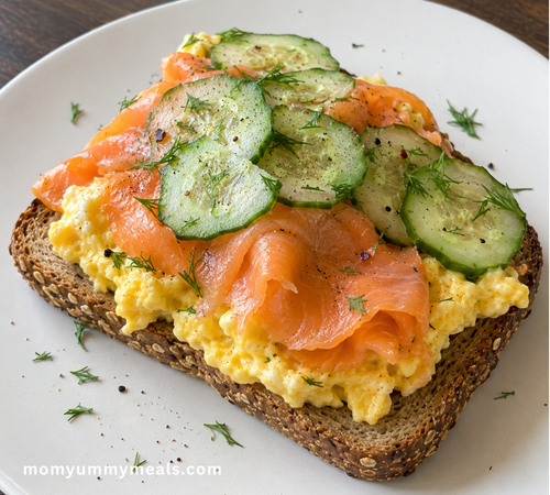High protein breakfast toast topped with scrambled eggs smoked salmon and cucumber