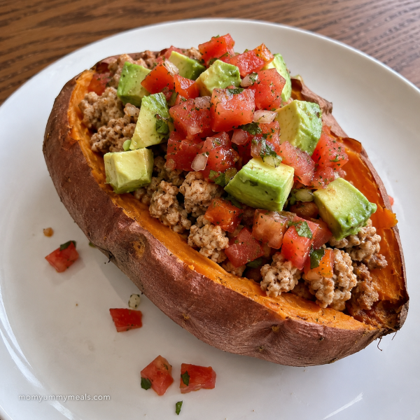 Sweet potato stuffed with ground turkey avocado salsa and tomatoes