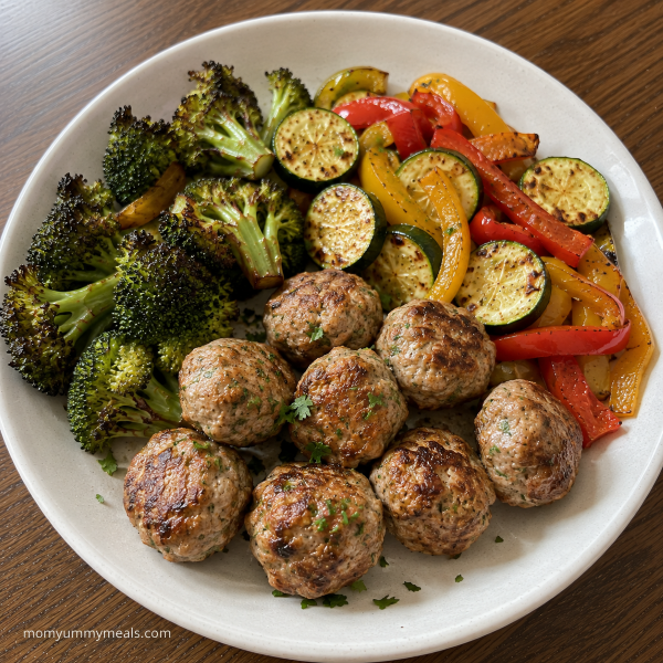 Turkey meatballs served with roasted broccoli zucchini and bell peppers