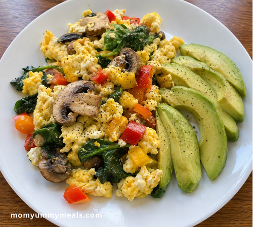 Veggie egg scramble with spinach mushrooms peppers and avocado