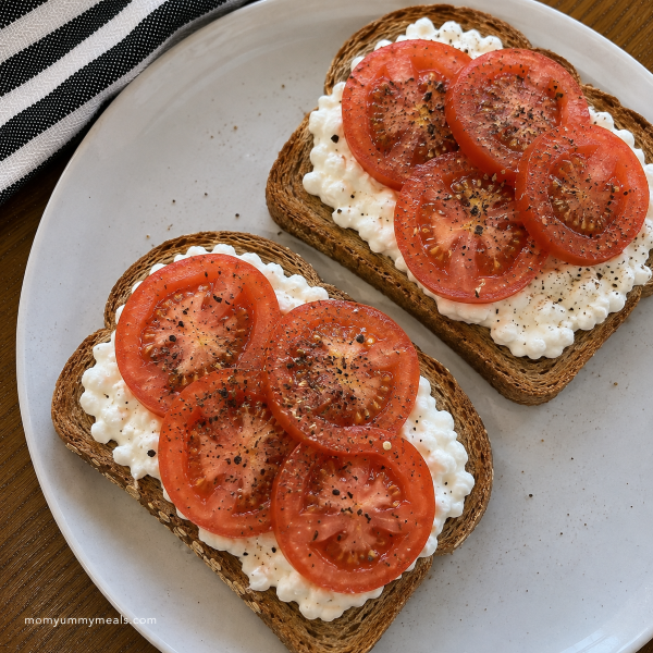 Whole grain toast with cottage cheese sliced tomatoes and seasoning